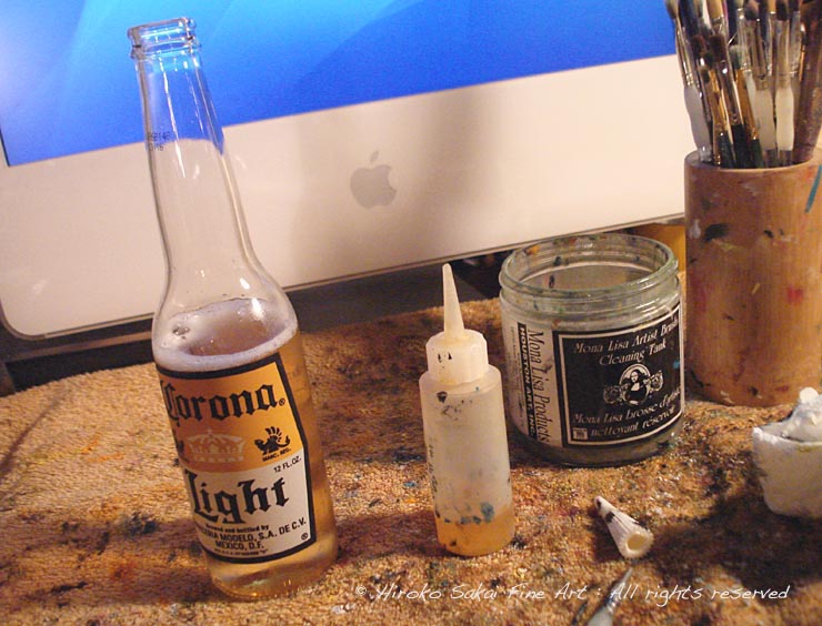 aritst's desk, evening working, computer, mac, beer, colona beer, painting brush wash bottle
