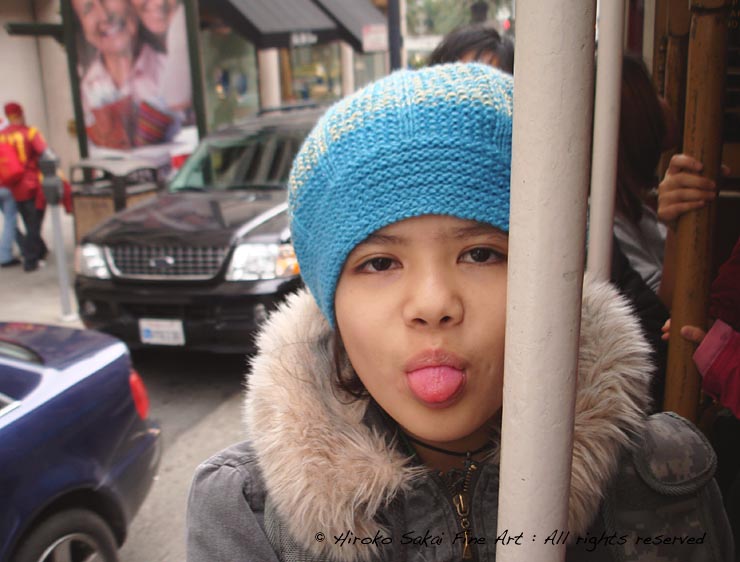 a girl, a girl sticking her tongue out, cable car, cable car ride, san francisco down town, california 